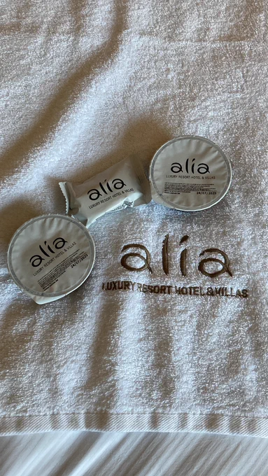 A towel with alia written on it. On the towel are food packets that have alia written on them