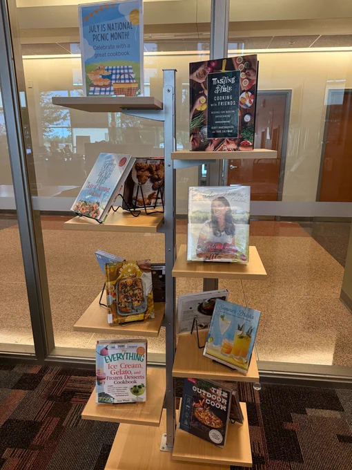 Freestanding book display with books about picnics.
