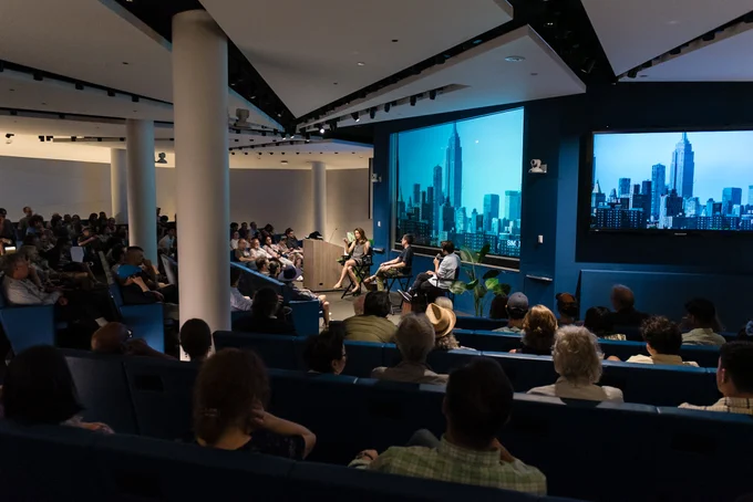 People sit in an auditorium