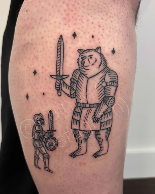 Leg tattoo in medieval engraving style depicting a soldier in armor, holding sword and shield about to face a big bear, also in armor wielding a sword. Stars frame them.
By @train.wrex on Instagram 