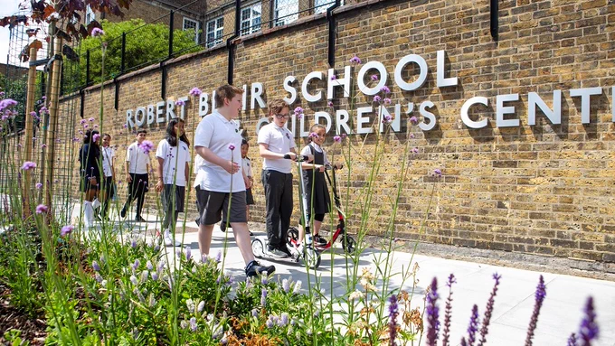 Schoolchildren walk and wheel on the improved streets outside Robert Blair Primary School