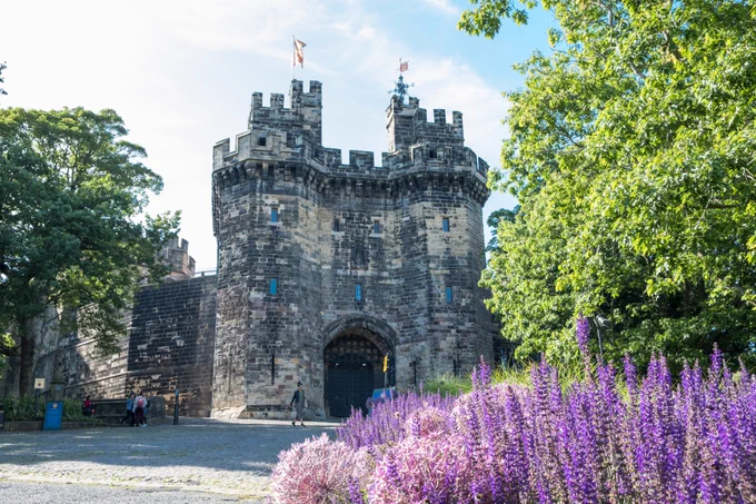 Image shows the front of Lancaster Castle in spring.