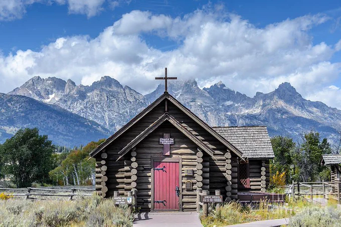Located in the Grand Tetons National Park.
This tiny chapel was built in 1925 on land donated by Maud Noble. It is still a functioning Episcopal church, though seasonally. It was constructed so the early settlers would not have to make the long ride into Jackson for Sunday services. The structure also served guests and employees of the dude ranches that stretched north of Jackson along the base of the Teton Range.