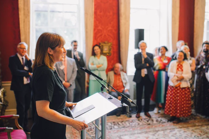 Chancellor of the Exchequer Rachel Reeves stood at a lectern giving a speech to an audience