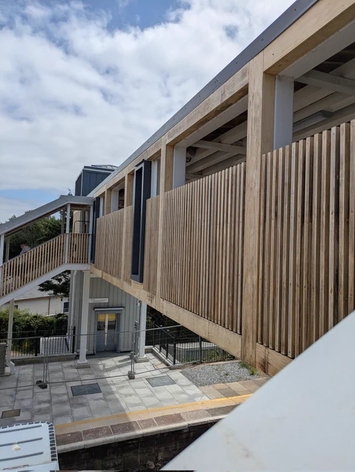 View of the new accessible footbridge at St Erth station, the sides are clad in timber. Photo taken from the footbridge