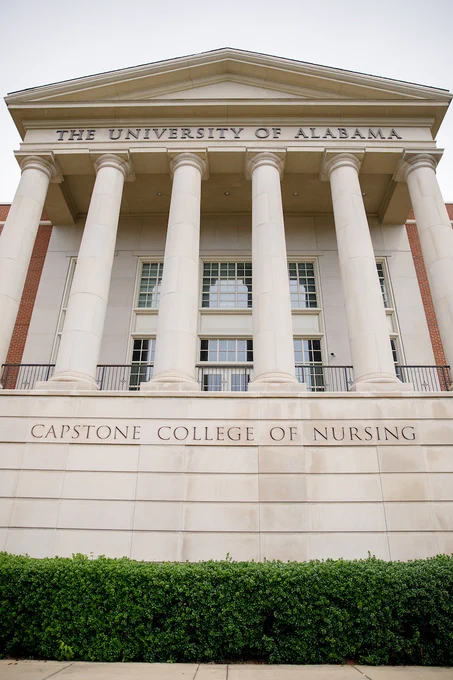 Front view of the University of Alabama's Capstone College of Nursing building with large columns and a grand entrance.