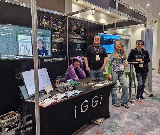 iggi researchers and staff in front of their expo stand at the develop brighton conference