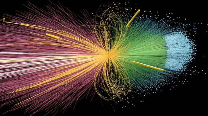 An artist’s depiction of a Higgs boson interaction in 3D. Against a black background, an eight-figure of faint yellow lines and dots is in the middle of a black backdrop. To the right of the eight-figure, countless faint, pin-straight green and blue lines emanate radially from its middle intersection. To the left of the eight figure, countless faint, pin-straight pink and yellow lines, much longer than the green and blue lines emanate radially from the same intersection.