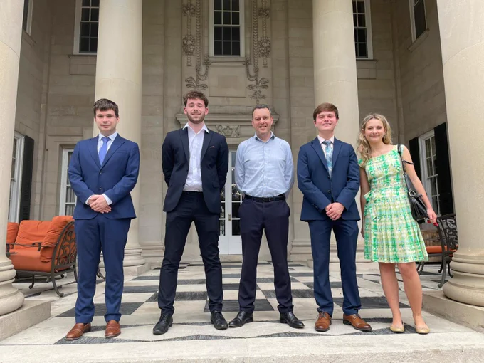 A photo of Colin with the interns. 