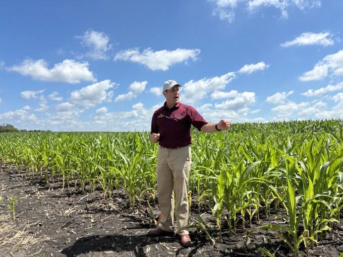Fabian Fernandez standing a corn field.