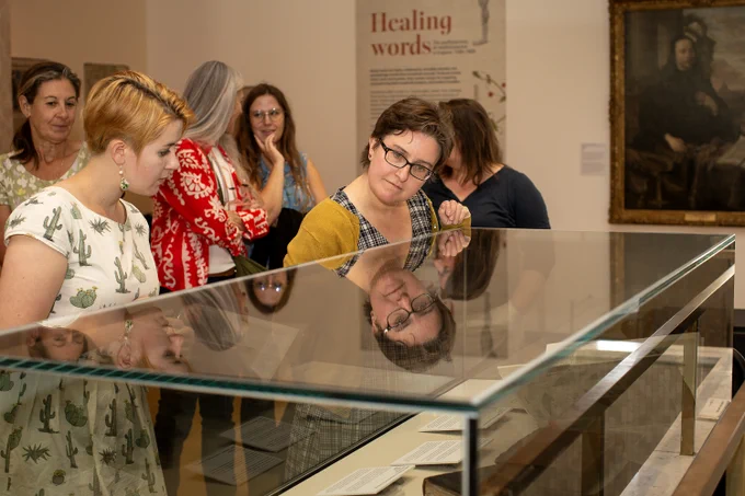 Visitors look into the display cases of an exhibition at the RCP.
