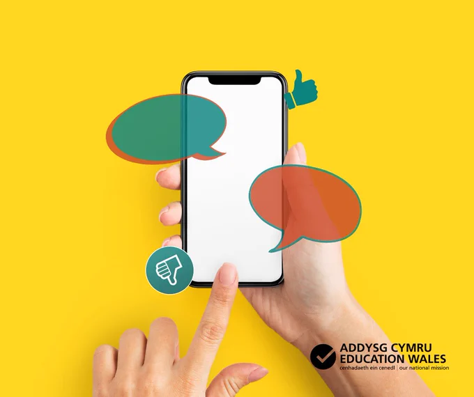Hand holding a smartphone with blank screen surrounded by colourful speech bubbles and thumbs up/down icons on a yellow background.