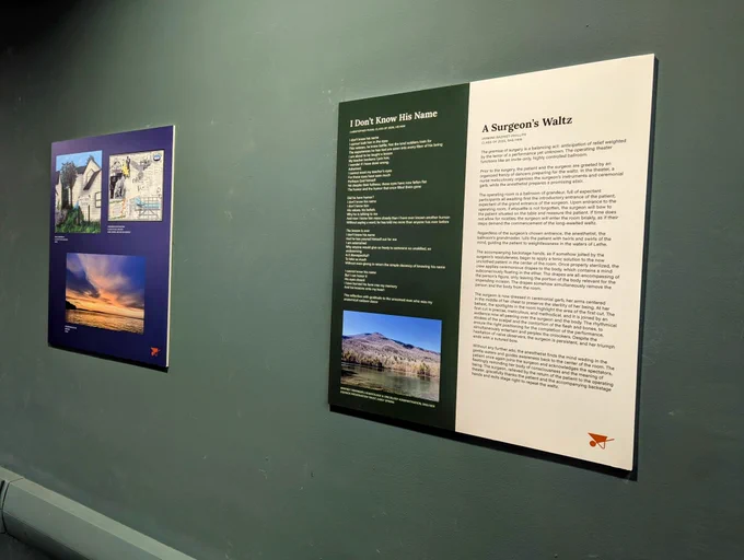 Two panels displaying art and poetry are on a green wall.