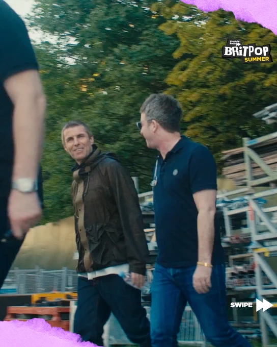 Liam and Noel Gallagher smiling at each other