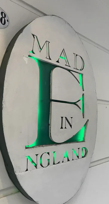 A sign that reads "MAD E IN NGLAND." The E larger and is meant to serve as a joiner between "MADE" and "ENGLAND" but the largeness of E and the relative smallness of the other words do not suggest a link.