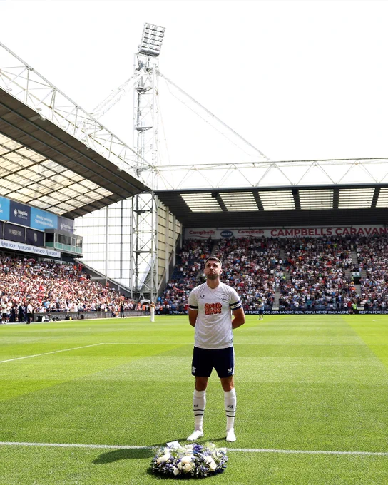 Photography of Preston player Ben Whiteman as he laid a wreath for Diogo Jota and Andre Silva in front of the Liverpool fans at Deepdale.
