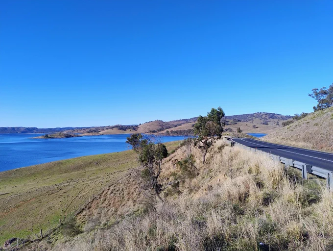 A perfect day with green farmland and Windemere Dam on the left and The Golden Highway on the right, just east of Mudgee. 