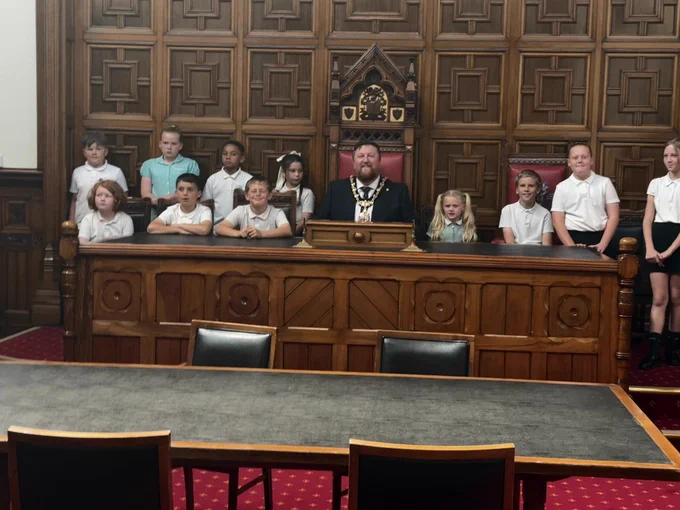 Mayor of St Helens Borough, Cllr Seve Gomez-Aspron, pictured with Rivington Primary School's school debate team in Council Chamber