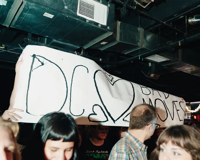 photo of a banner that reads "DC ❤️ Bad Moves" in the audience