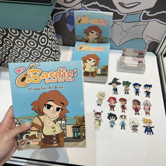 this is a photo of the of the art book and character stickers of Bardic: Quest for Love by Breadwork Games
