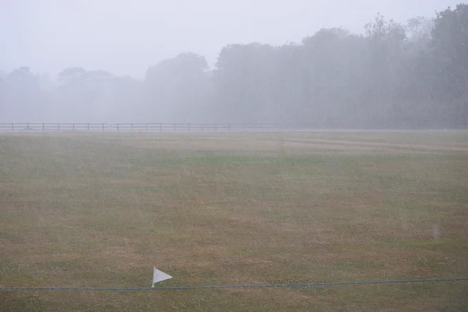 Rain lahses down onto empty cricket field