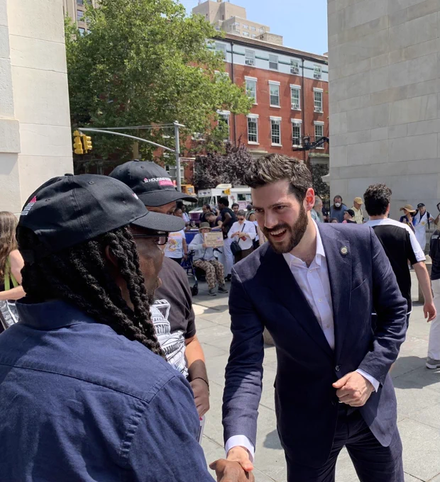 Assemblymember Alex Bores talking with advocates at an ADA 35th anniversary protest.