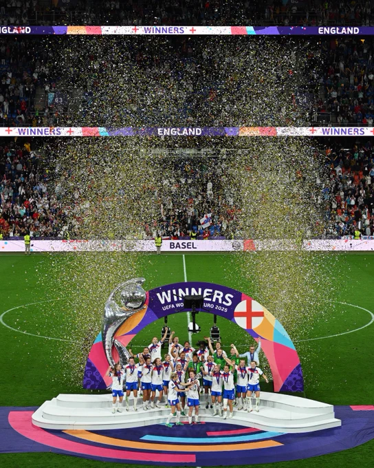England squad lift the European trophy as ticker tape shoots into the air. 