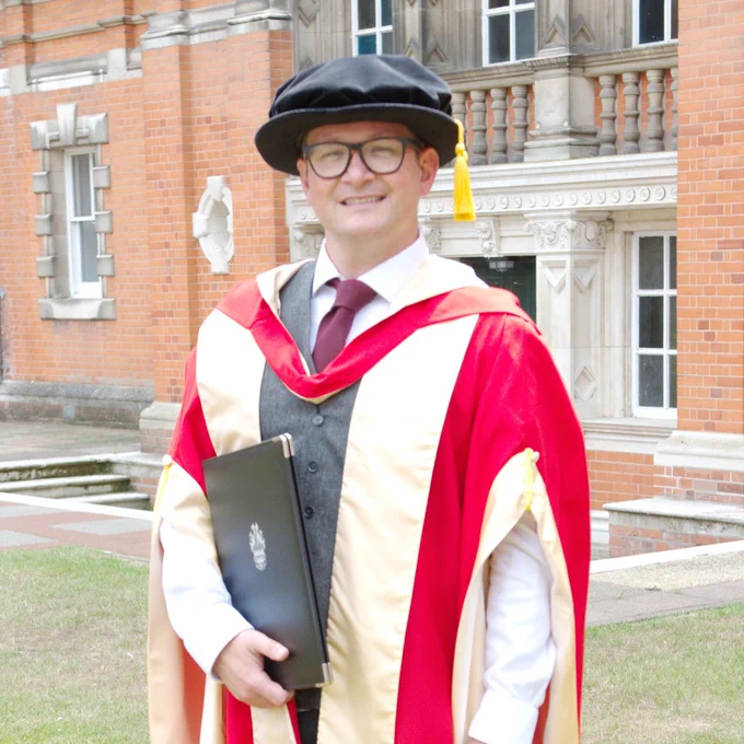 Solomon Rogers in graduation gown having been awarded an honorary degree