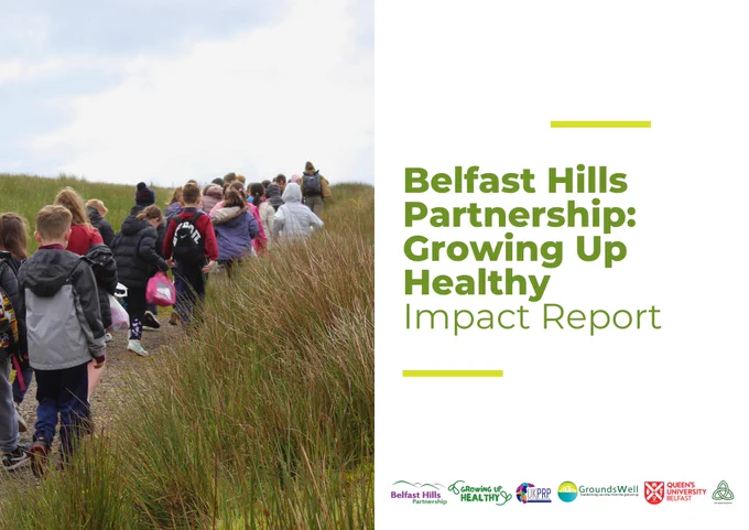Cover of report with an image of children in a group climbing a hill. The title reads Belfast Hills Partnership: Growing Up Healthy 
Impact Report. Logos show Belfast Hills Partnership, Growing Up Healthy, UKPRP, GroundsWell, Queen's University Belfast and West Belfast GP Federation
