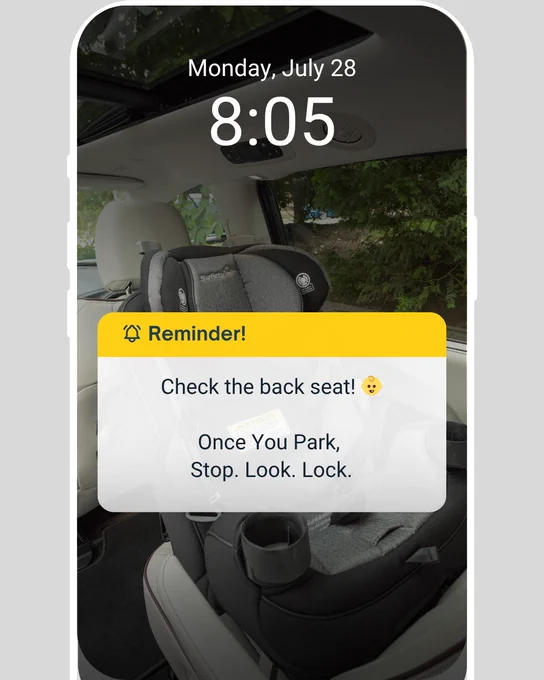 Interior view of a car displaying a safety reminder on a dashboard screen, reading "Reminder! Check the back seat! 😊 Once You Park, Stop. Look. Lock." The reminder is displayed over a background showing a car seat.
