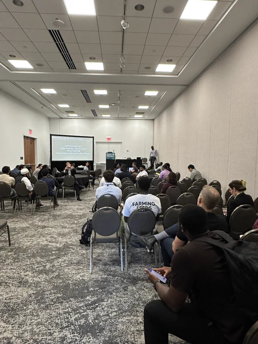 Image of meeting room full of attendees