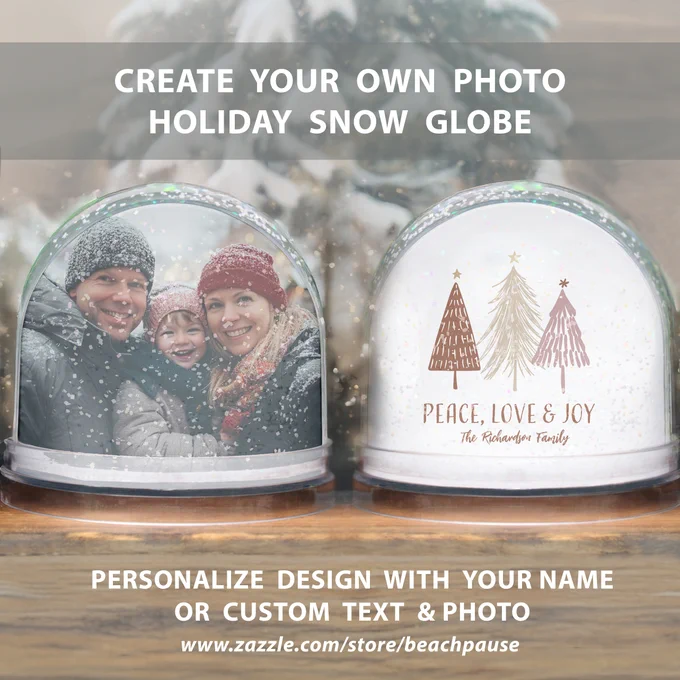 A festive snow globe with “Peace, Love & Joy” in elegant script, framed by snowy red, gold, and pink Christmas trees. Includes customizable photo and name area, ideal for heartfelt holiday gifting or mantel décor.