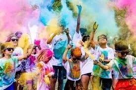 Students covered in colored powder at a Color Run event