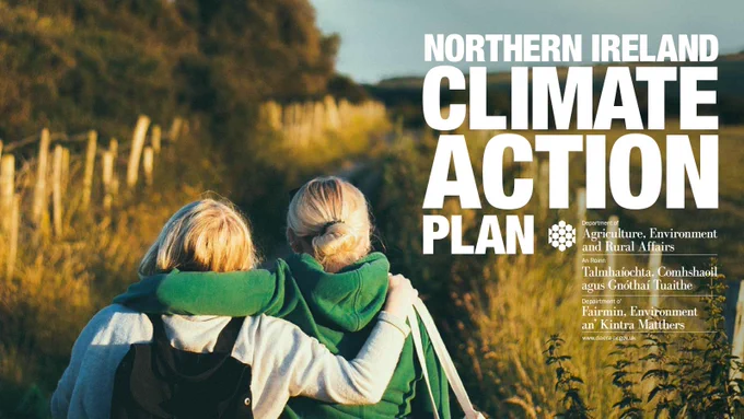 Image of two people walking in field. Reads Northern Ireland Climate Action Plan. 
