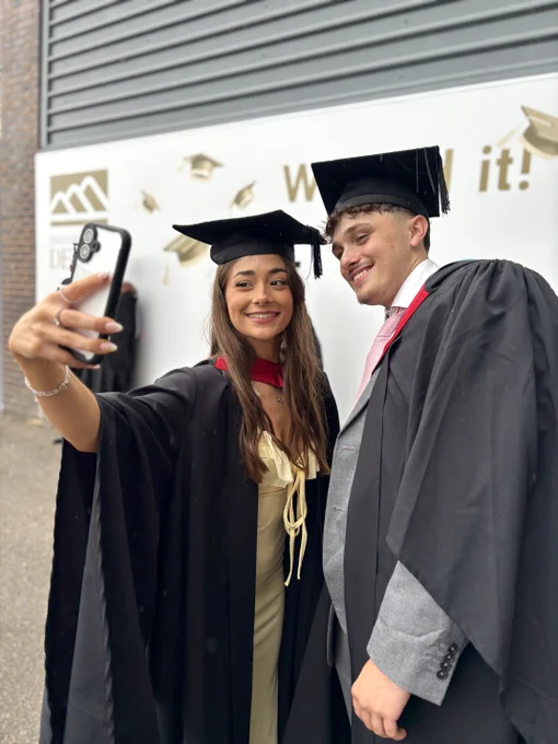 Two graduates taking a selfie