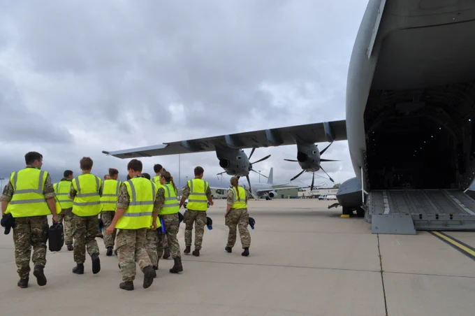 12 air cadets in greens and high vis jacket walking on left side of RAF A00M with ramp down.