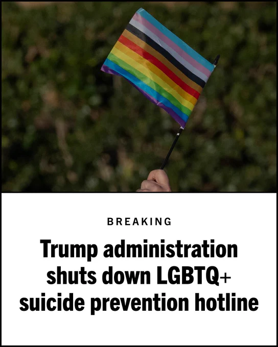A hand holding a LGBTQ  pride flag, with a blurred green foliage background. 

Text at the bottom of the image reads: BREAKING
Trump administration shuts down LGBTQ  suicide prevention hotline.