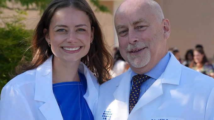 Emergency medicine faculty member Dr. McCormack stands with his daughter, a Class of 2029 medical student