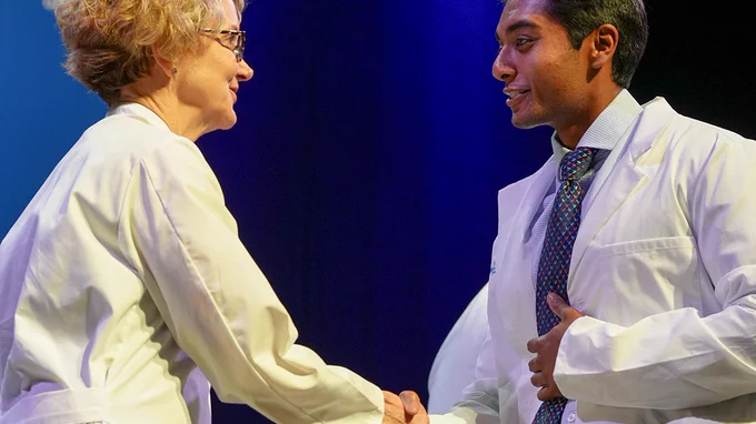 Dean Brashear shakes the hand of a new medical student 