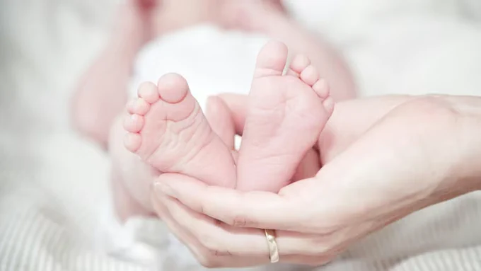 Picture of baby's feet being held by an adult