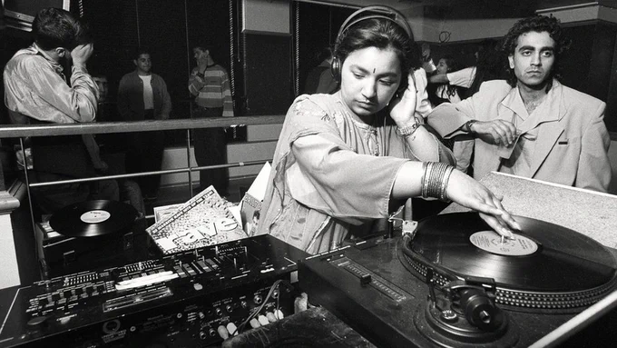 DJ Radical Sista cues up a record at a Bradford Daytimer, c.1989. Image Credit: Tim Smith.