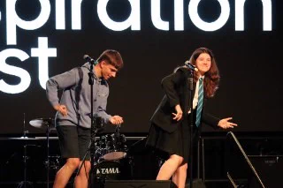 Secondary pupils on stage performing the dance to 'Rasputin'
