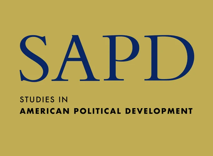 Logo of Studies in American Political Development featuring the acronym "SAPD" in large blue letters on a gold background, with the full organization name spelled out in smaller blue type below.