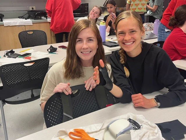 Aja and Abbey with Angelina and Leah in the background (second year OT students) working on their splints.