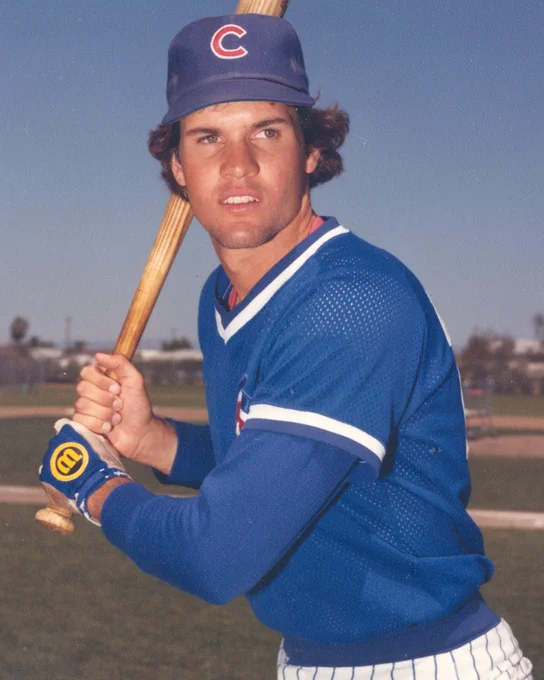 Batting portrait of Ryne Sandberg wearing a Cubs uniform and posed in his right-handed stance.