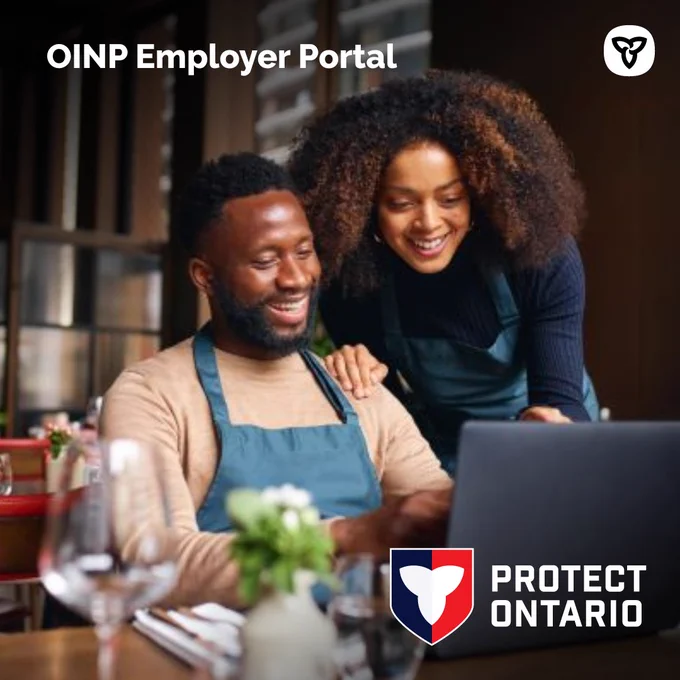 Two workers looking at a laptop