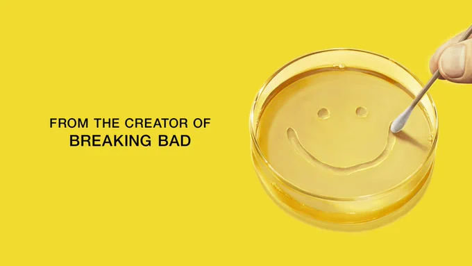 A Petri dish in the middle of a yellow background. A hand  is seen outlining a smiley face in the Petri dish. On the side of the image is text that reads, "From the Creator of Breaking Bad."