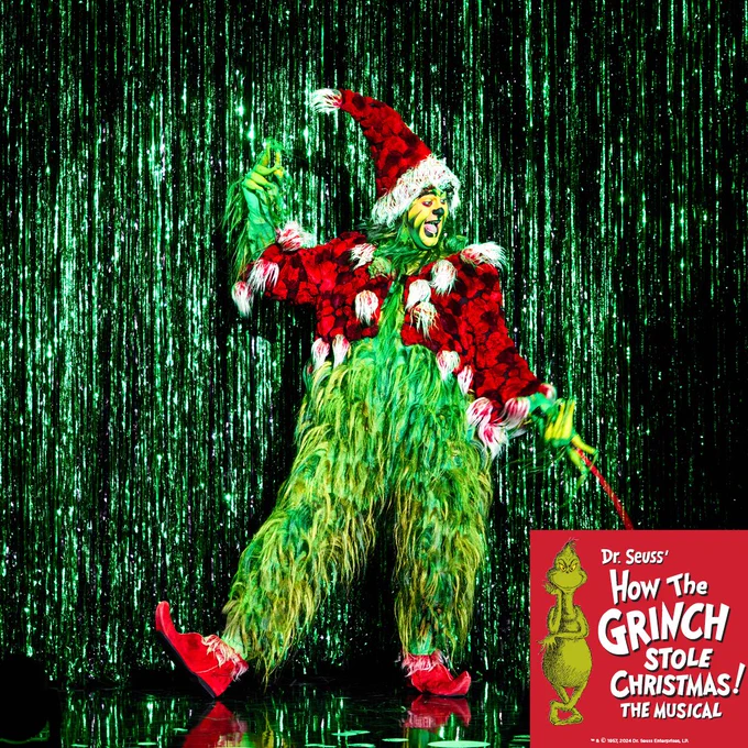 Performer in a colorful Grinch costume on stage, from Dr. Seuss' 'How The Grinch Stole Christmas! The Musical', with a sparkling green backdrop.