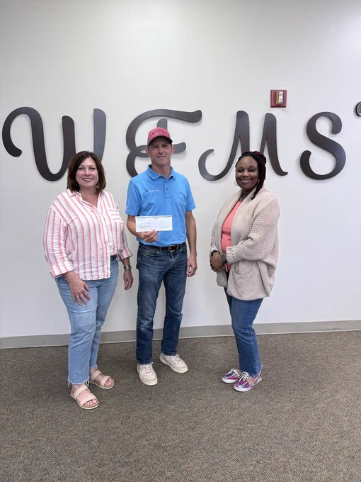 Administrators accept check from representative from Lott Oil Company