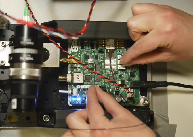 Engineer working on a laser circuit board